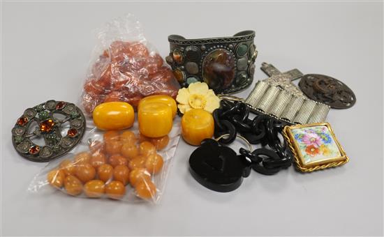 A small group of loose amber beads and mixed costume jewellery.